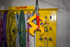A photo showing the Rail Clamp infront of a Carl Stahl branded stand. The clam is currently held in it's open position